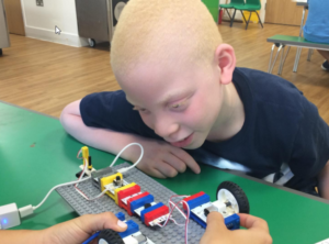 An image of a kid playing with a circuit