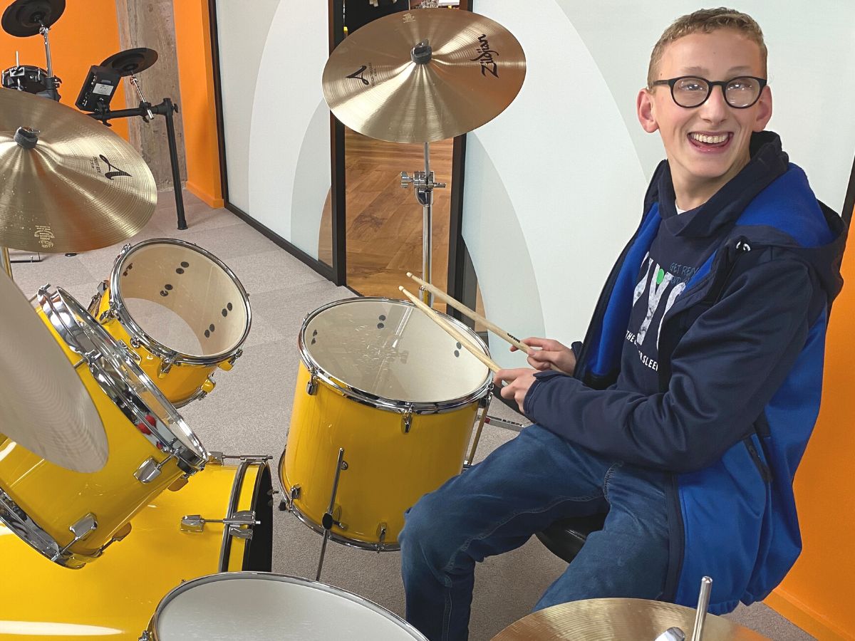 A teenager playing the drums