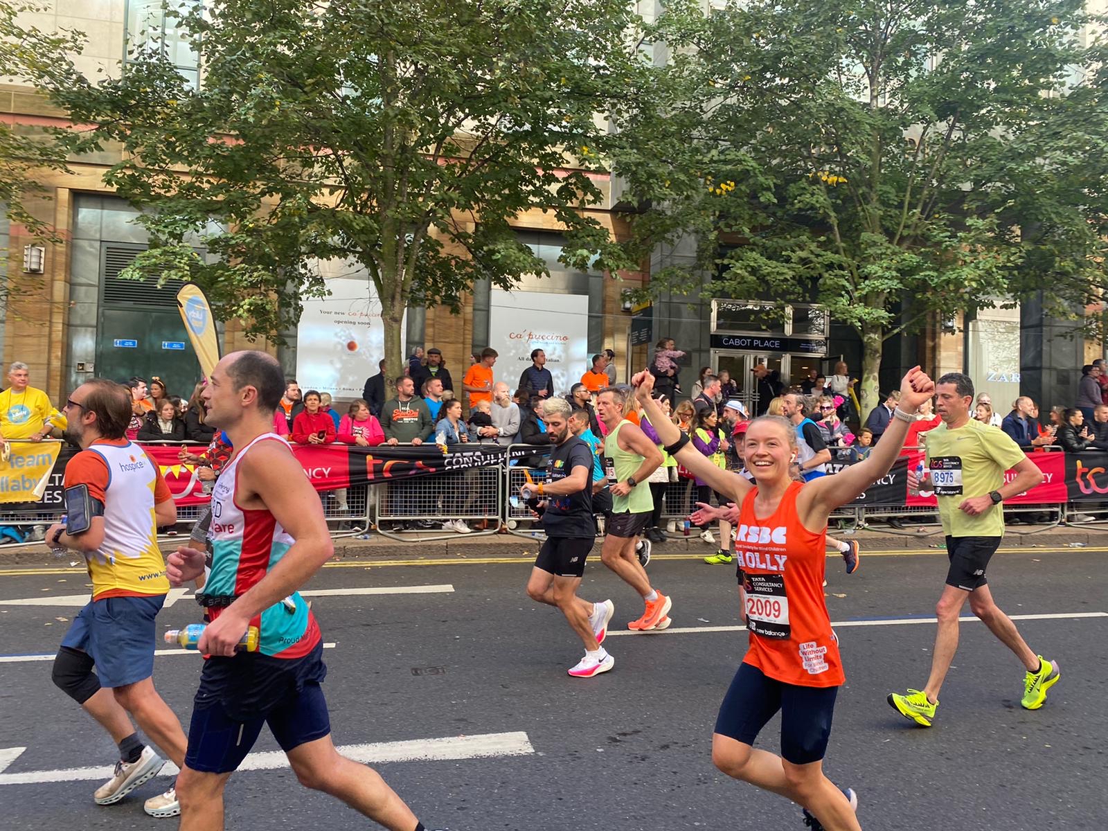 A RSBC runner looking happy with arms up