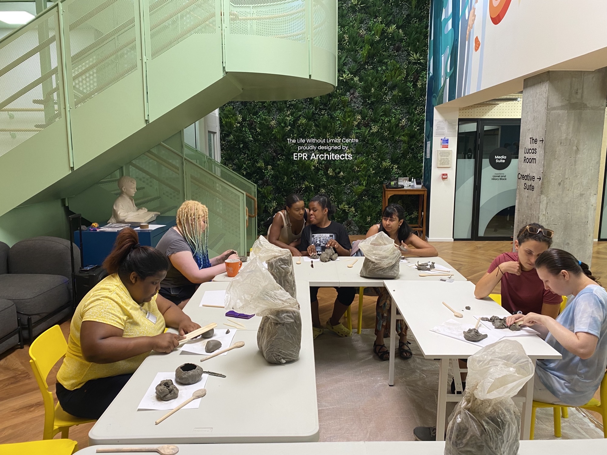 Young people having a sculpture activity in the LWLC atrium