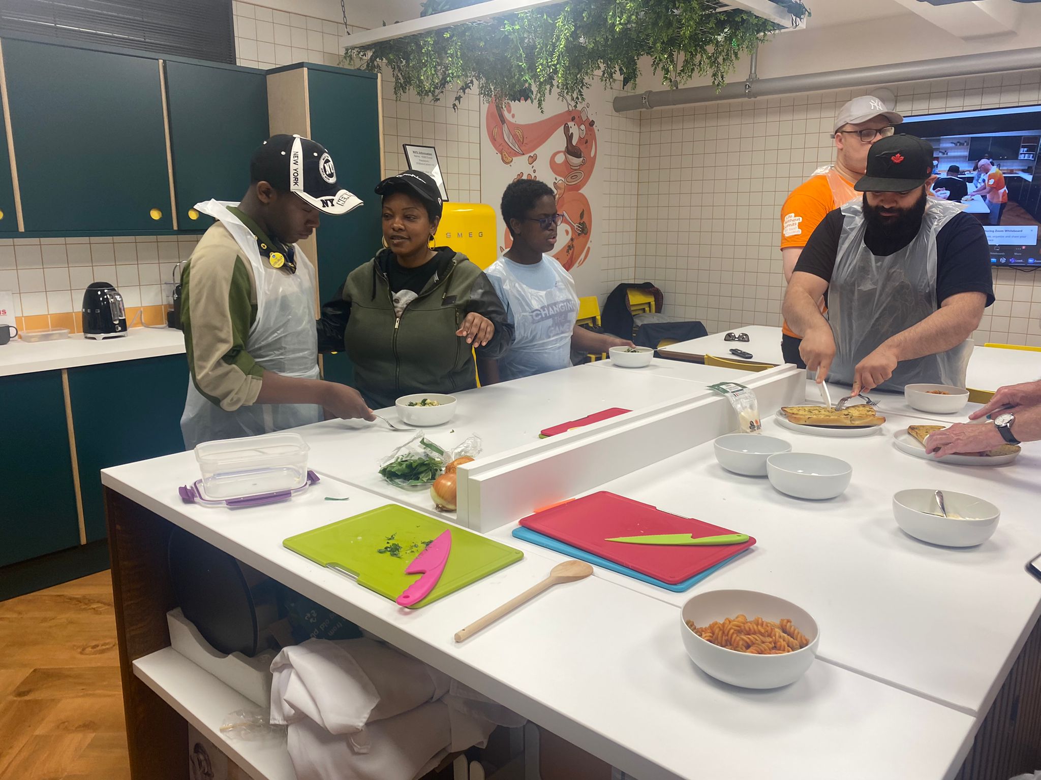 A group of young people cooking in a kitchen