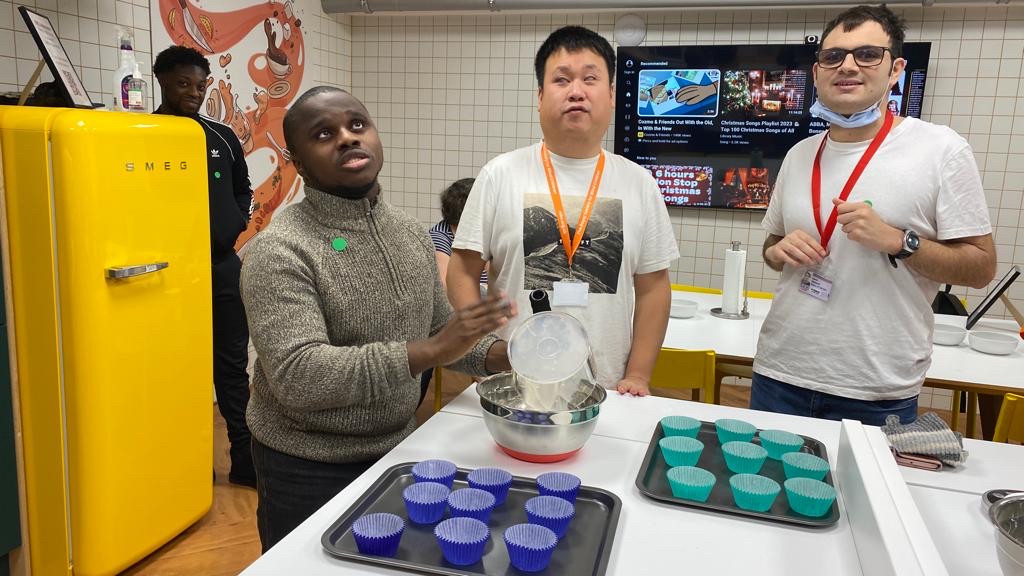 3 young men baking in a kitchen