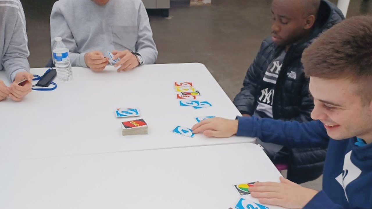 Dorton college students sitting around a table and playing Braille Uno 