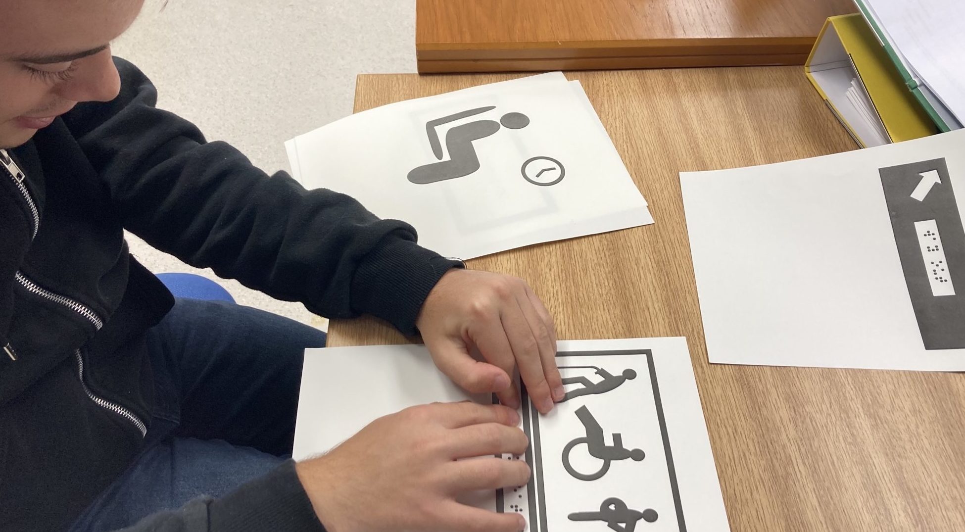 A Dorton College student learning transport signs in Braille