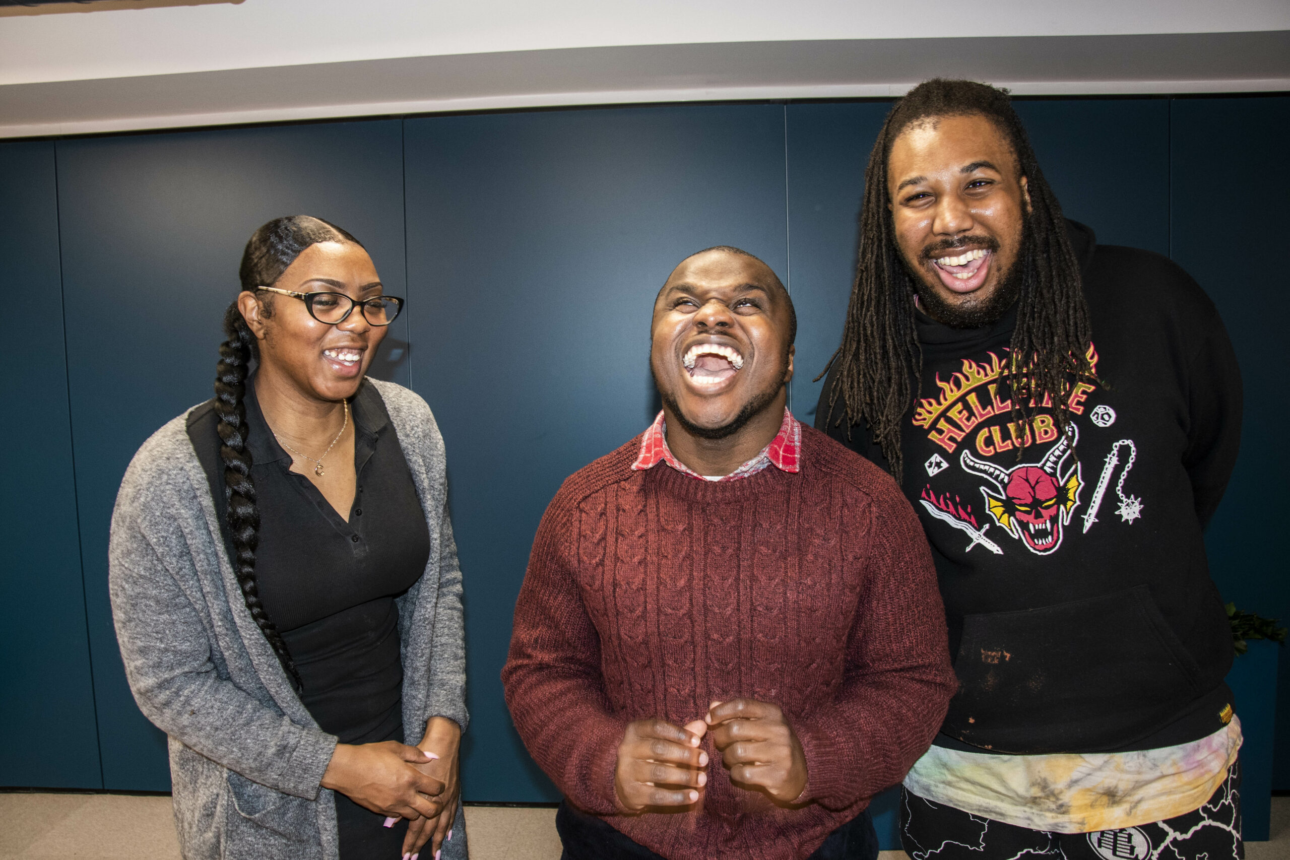 Three happy people laughing