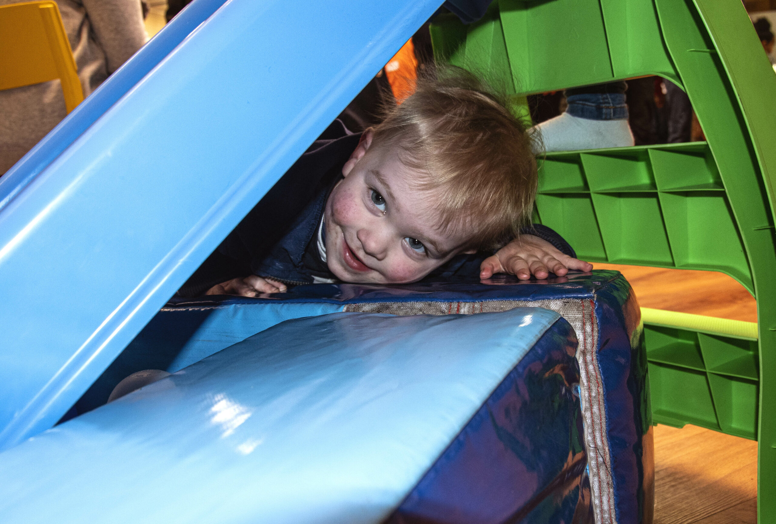 A child playing and smiling at the camera