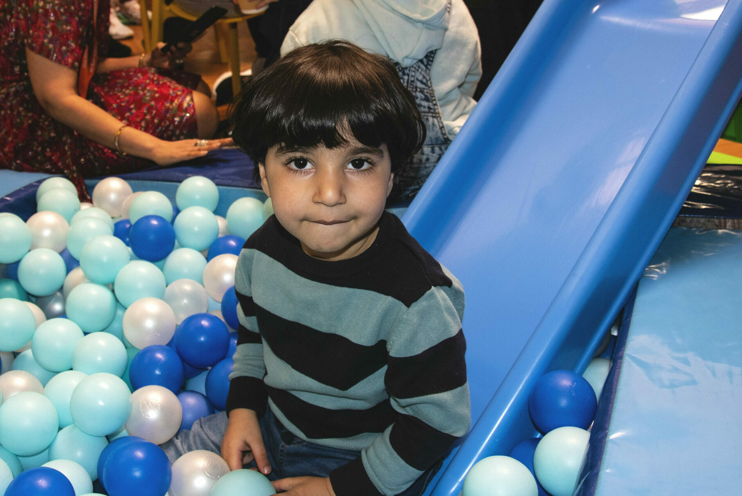 A child playing in a ball pit