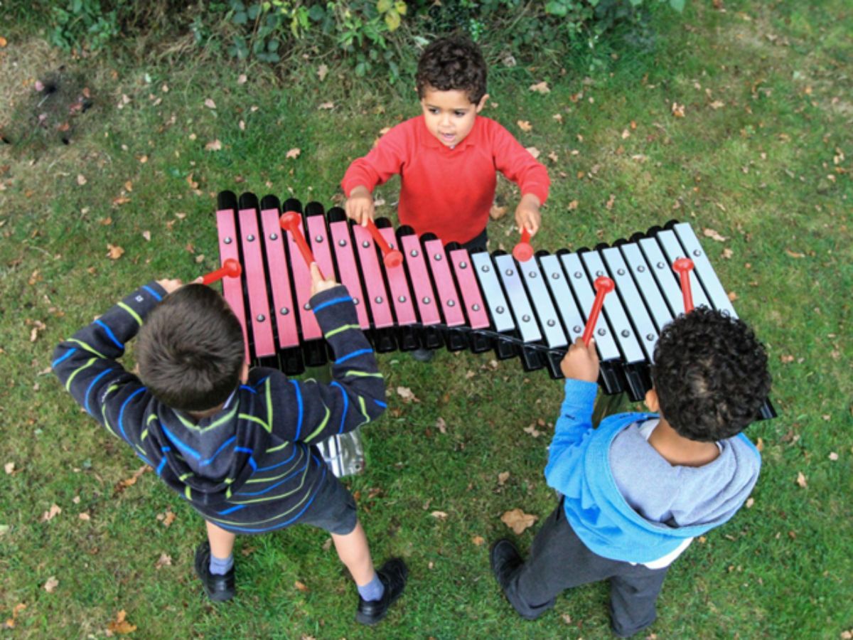 Percussion Play’s Duo xylophone being played outside by 3 children