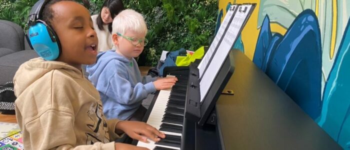 A child playing piano with his eyes closed.