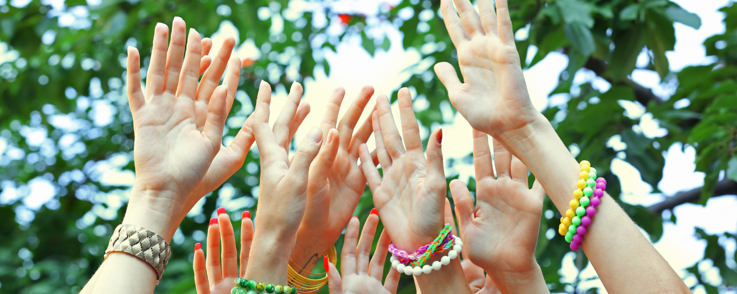 A photo of hands raised in the air.