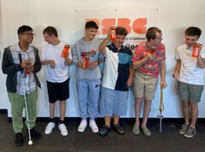 A group of six blind and partially sighted college students holding water bottles