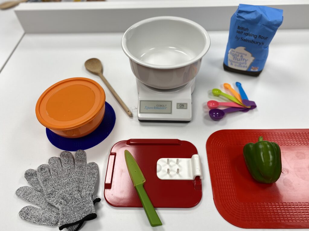 Brightly coloured and high contrasting cooking utensils on a kitchen counter.