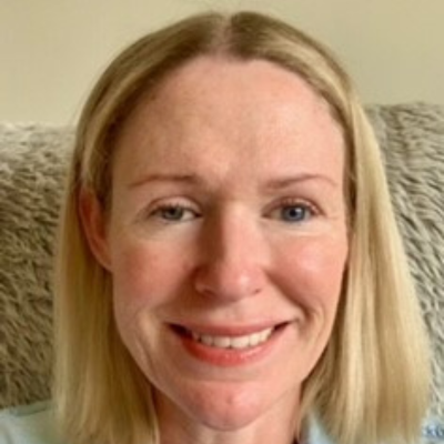 Headshot of Suzy, the Monitoring Impact and Evaluation Analyst at RSBC. Suzy is a light-skinned woman with shoulder length blonde hair. She is wearing a pale blue shirt, and is smiling brightly at the camera.