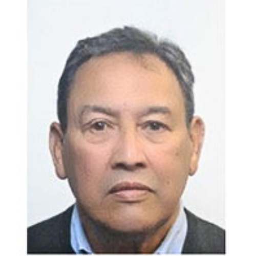 Headshot of Viv Lawrence, an RSBC Vice-President. Viv is a medium-light skinned man with short dark grey hair. He is wearing a blue shirt with a grey jumper. He is looking seriously at the camera.